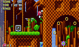 Knuckles climbing a ring loop in Green Hill Zone in Sonic Mania.